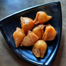 Crispy khova sweet samosas — fried pastry filled with sweetened milk solids